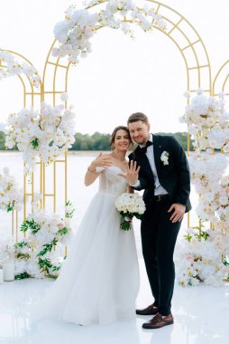 wedding ceremony of the newlyweds on the pier near the restaurant