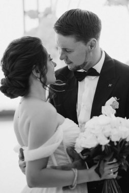 wedding ceremony of the newlyweds on the pier near the restaurant
