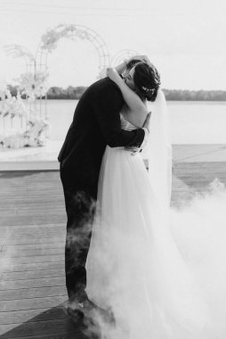 the first dance of the bride and groom inside a restaurant with heavy smoke