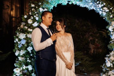 newlyweds happily cut, laugh and taste the wedding cake