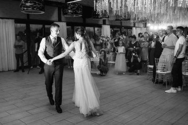 the first dance of the bride and groom inside a restaurant with heavy smoke