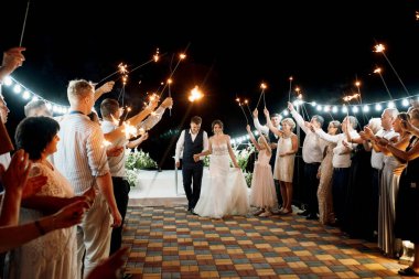 newlyweds at a wedding in the corridor of sparklers