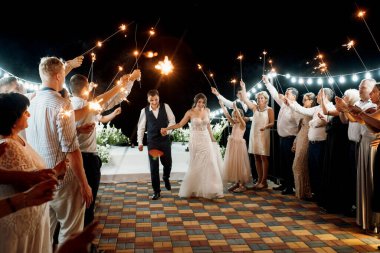 newlyweds at a wedding in the corridor of sparklers