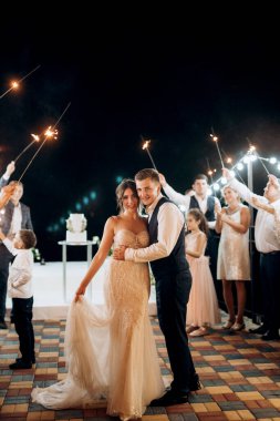 newlyweds at a wedding in the corridor of sparklers