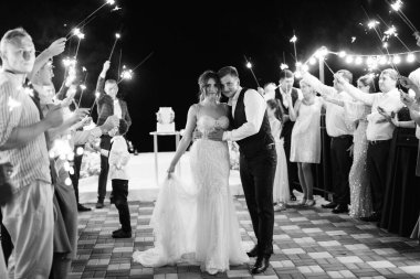 newlyweds at a wedding in the corridor of sparklers