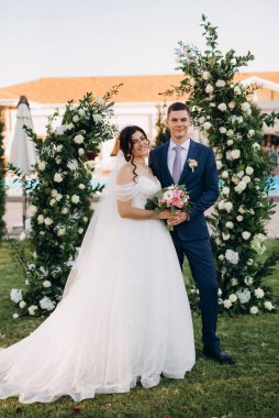 wedding ceremony of the newlyweds on the glade near the restaurant