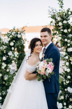 wedding ceremony of the newlyweds on the glade near the restaurant