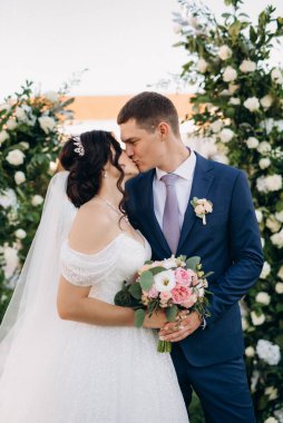 wedding ceremony of the newlyweds on the glade near the restaurant