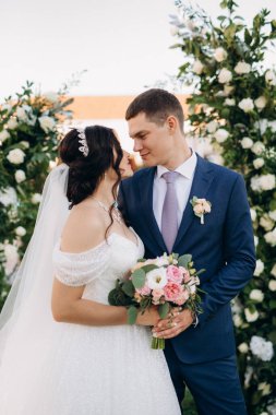 wedding ceremony of the newlyweds on the glade near the restaurant
