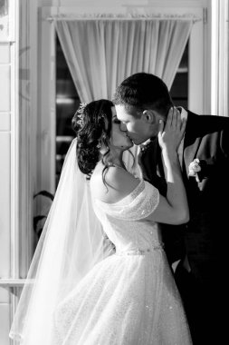 newlyweds happily cut, laugh and taste the wedding cake