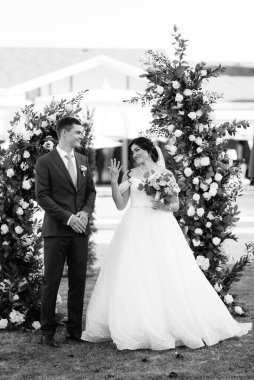 wedding ceremony of the newlyweds on the glade near the restaurant