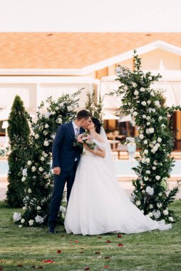 wedding ceremony of the newlyweds on the glade near the restaurant