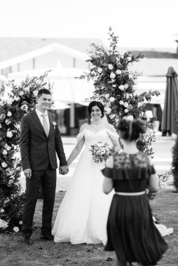 wedding ceremony of the newlyweds on the glade near the restaurant