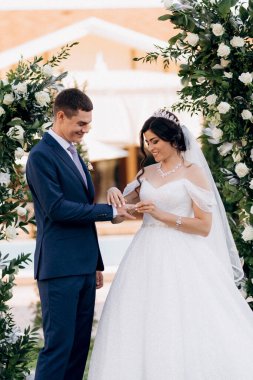 wedding ceremony of the newlyweds on the glade near the restaurant