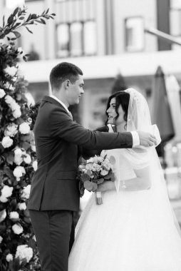 wedding ceremony of the newlyweds on the glade near the restaurant