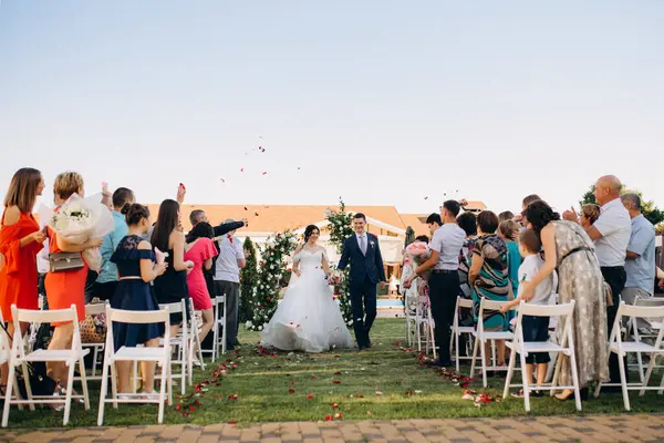 wedding ceremony of the newlyweds on the glade near the restaurant