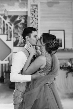 the first dance of the bride and groom inside a restaurant with heavy smoke