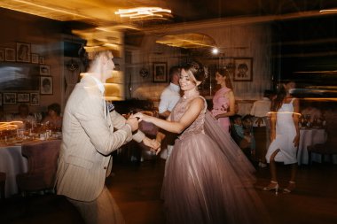 the first dance of the bride and groom inside a restaurant with heavy smoke