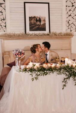 portrait of the newlyweds at the presidium at the wedding banquet clipart