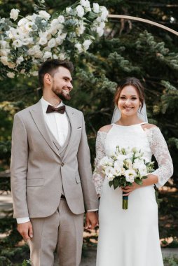 wedding ceremony of the newlyweds on the glade near the restaurant