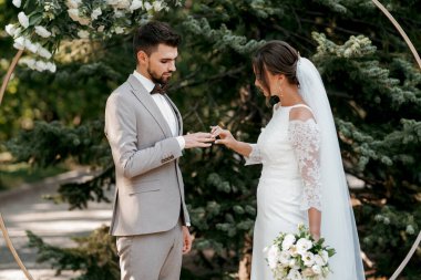 wedding ceremony of the newlyweds on the glade near the restaurant