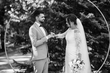 wedding ceremony of the newlyweds on the glade near the restaurant