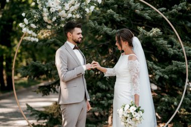 wedding ceremony of the newlyweds on the glade near the restaurant