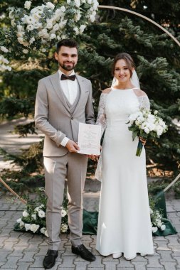 wedding ceremony of the newlyweds on the glade near the restaurant