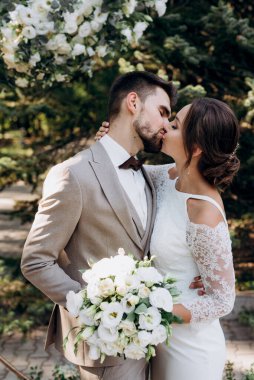 wedding ceremony of the newlyweds on the glade near the restaurant