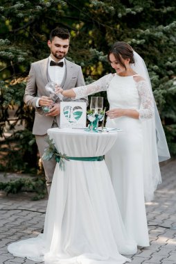 wedding ceremony of the newlyweds on the glade near the restaurant