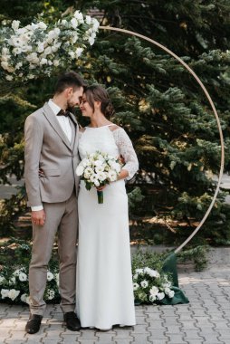 wedding ceremony of the newlyweds on the glade near the restaurant