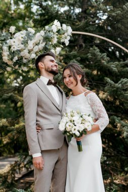 wedding ceremony of the newlyweds on the glade near the restaurant
