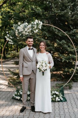 wedding ceremony of the newlyweds on the glade near the restaurant