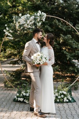 wedding ceremony of the newlyweds on the glade near the restaurant