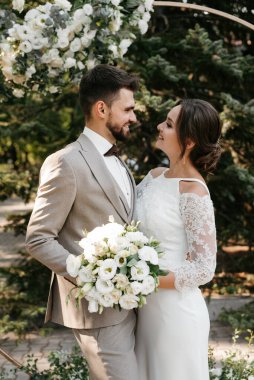 wedding ceremony of the newlyweds on the glade near the restaurant