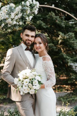 wedding ceremony of the newlyweds on the glade near the restaurant