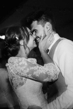 the first dance of the bride and groom inside a restaurant with heavy smoke