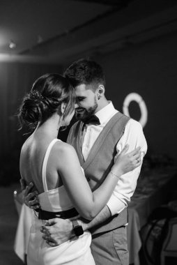 the first dance of the bride and groom inside a restaurant with heavy smoke