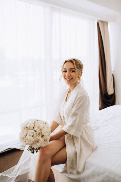 black-haired bride girl getting ready for groom in boudoir