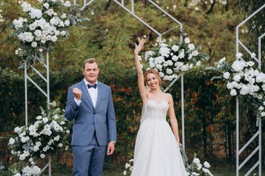 wedding ceremony of the newlyweds on the glade near the restaurant