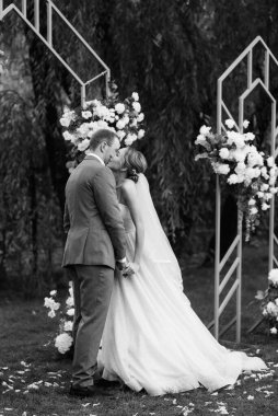 wedding ceremony of the newlyweds on the glade near the restaurant