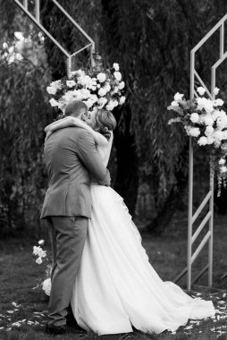 wedding ceremony of the newlyweds on the glade near the restaurant