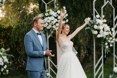 wedding ceremony of the newlyweds on the glade near the restaurant