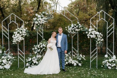 wedding ceremony of the newlyweds on the glade near the restaurant