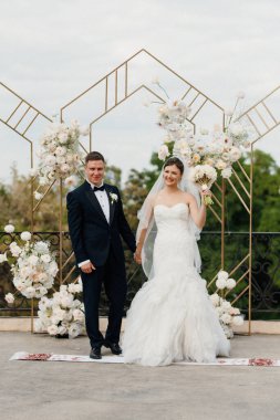 Yeni evlilerin düğün seremonisi nehrin arka planındaki restoranda.