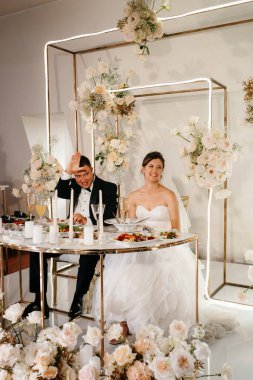 Yeni evlilerin portresi düğün şöleninde başkanlık makamında.