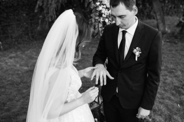 wedding ceremony of the newlyweds on the glade near the restaurant