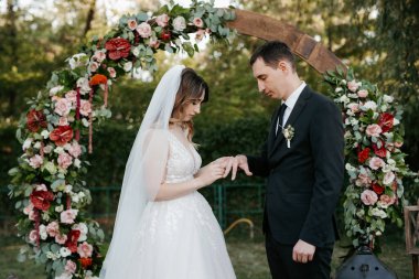 wedding ceremony of the newlyweds on the glade near the restaurant