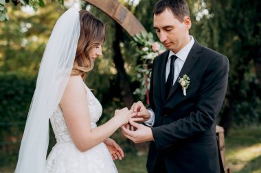 wedding ceremony of the newlyweds on the glade near the restaurant