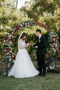 wedding ceremony of the newlyweds on the glade near the restaurant